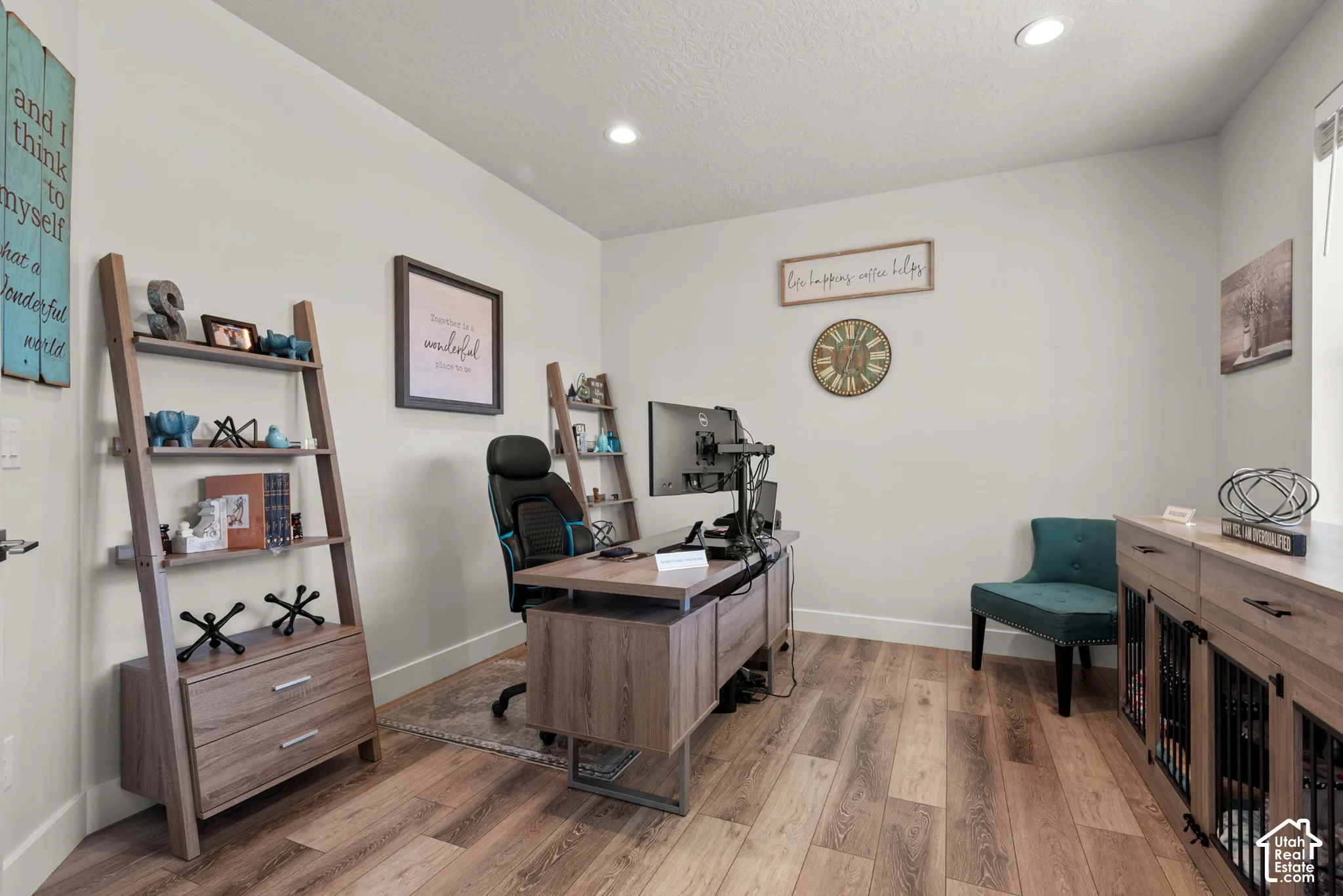 Bright room featuring wood-finish flooring and recessed lighting