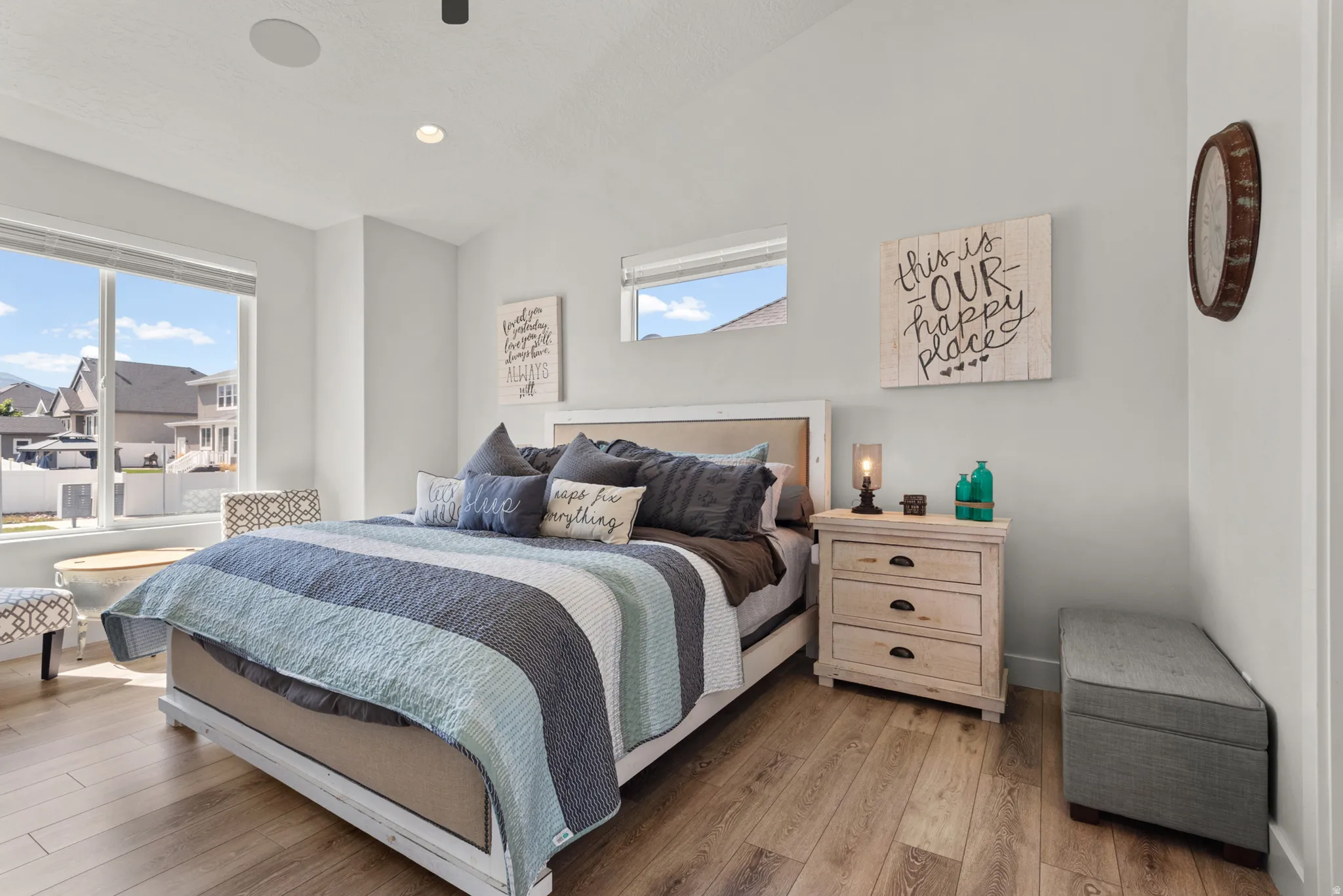 Bedroom featuring wood-finish flooring, large windows, and a vaulted ceiling with recessed lighting