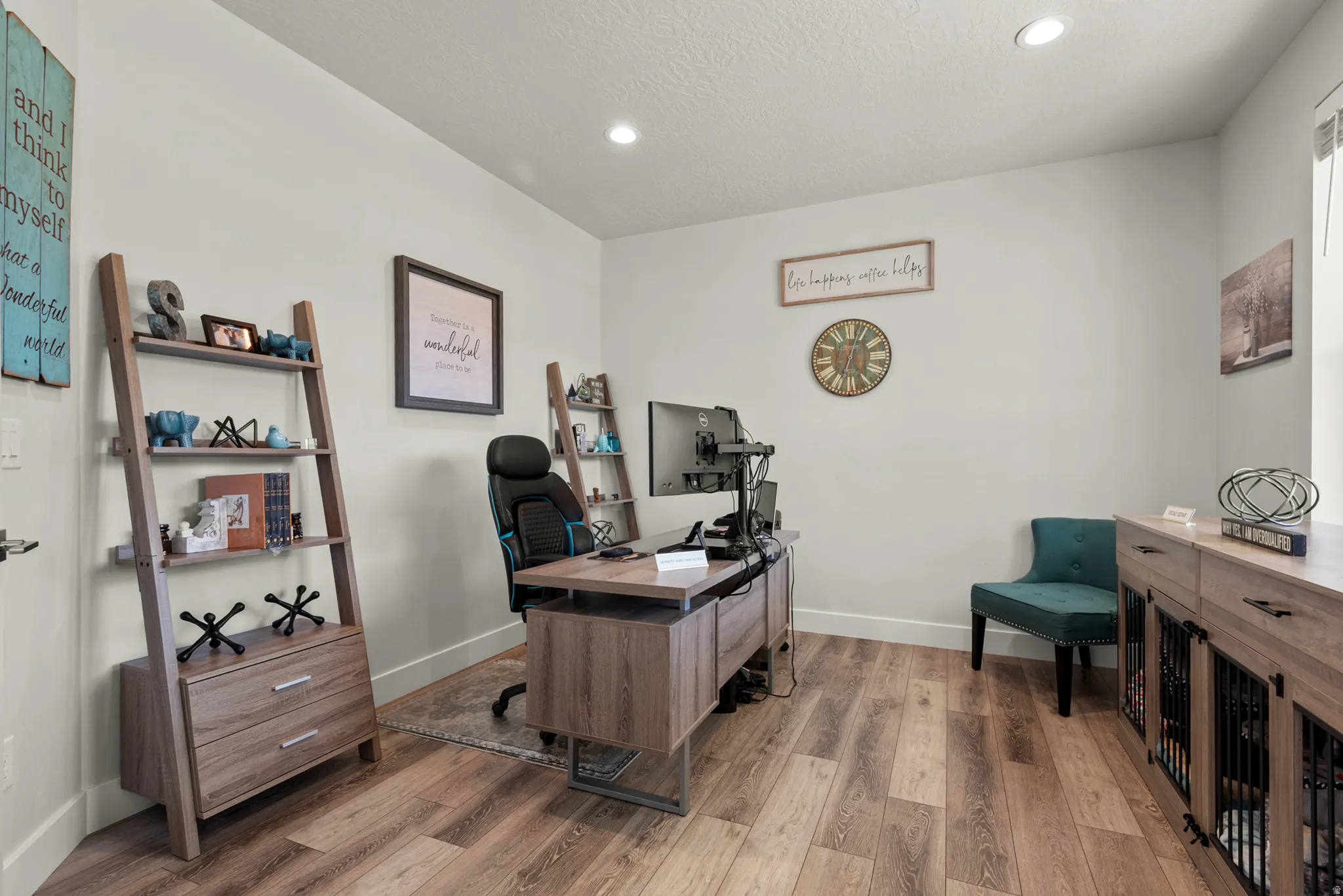 Bright room featuring wood-finish flooring and recessed lighting