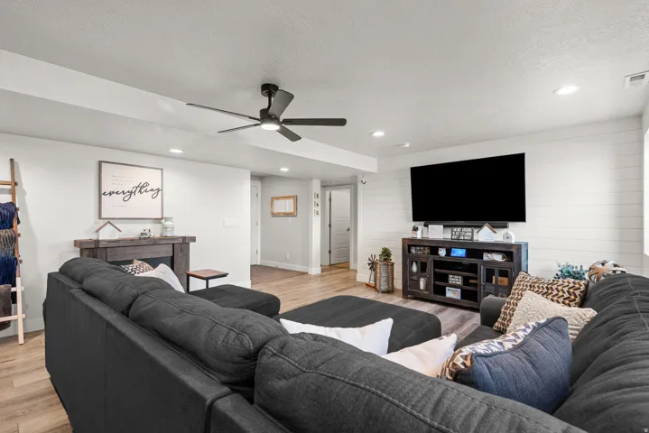 Open living area featuring wood-finish flooring, recessed lighting, and a modern ceiling fan