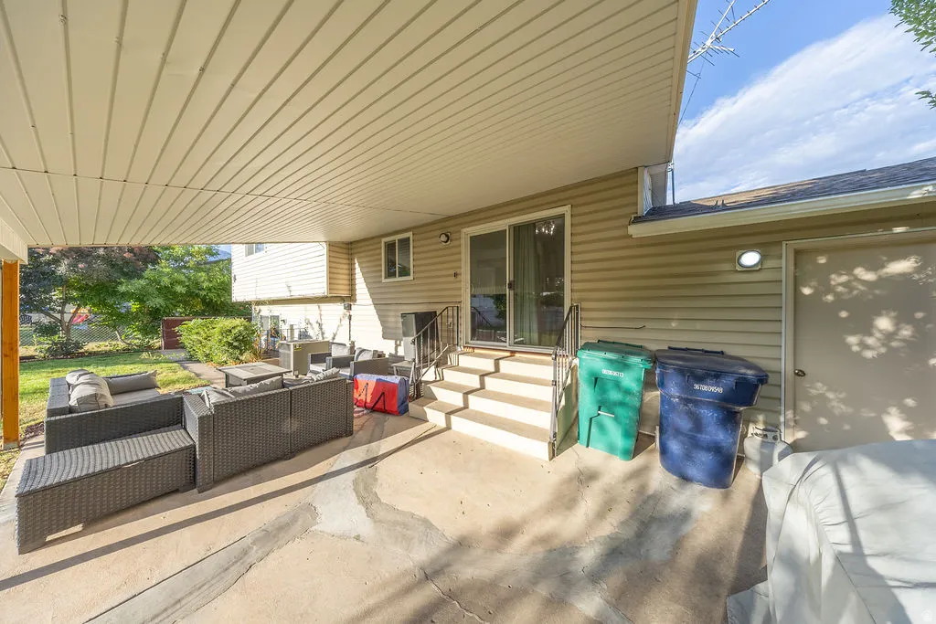Covered concrete patio extending from the residence
