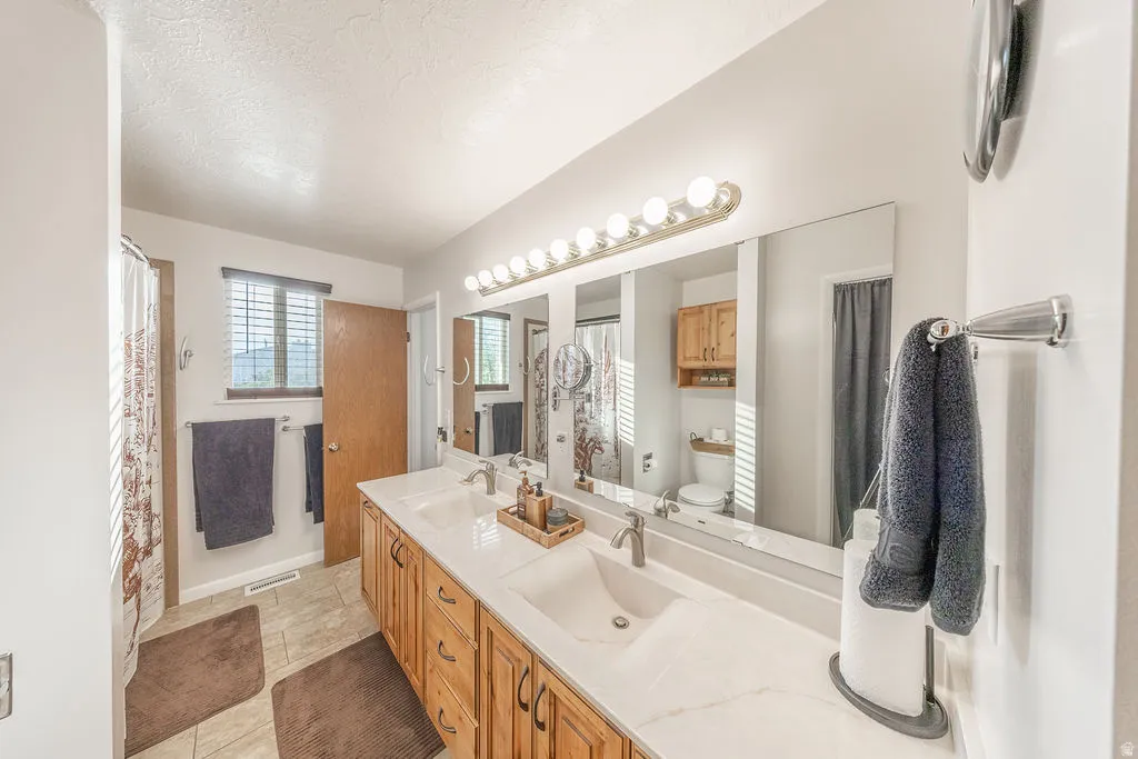 Double vanity with integrated sinks and a light-toned countertop