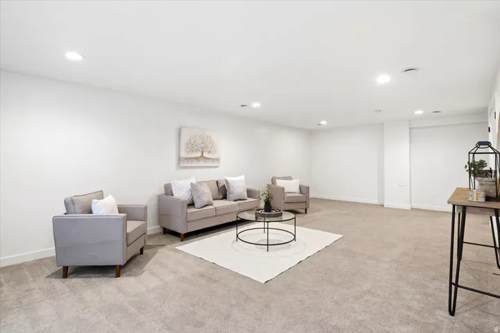 Spacious room featuring neutral carpeting, recessed lighting, white walls, and white trim
