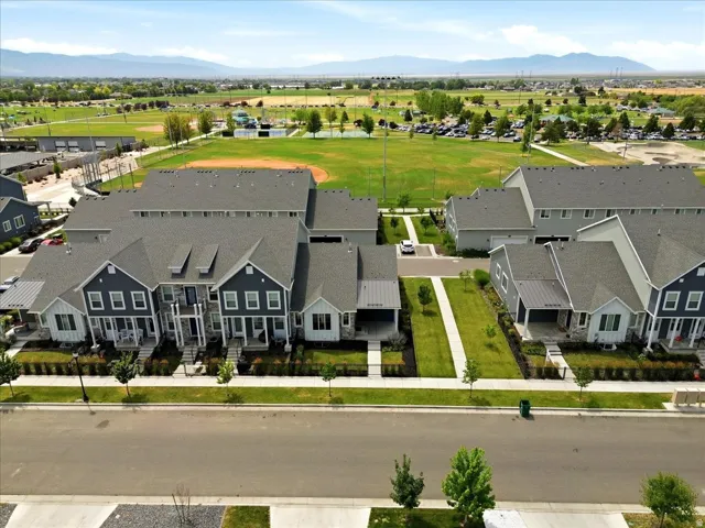 Modern townhome community featuring varied facade treatments, pitched shingle roofs, and distinct covered entryways