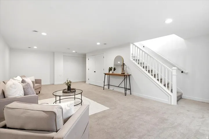 Spacious room featuring neutral carpet flooring and white walls