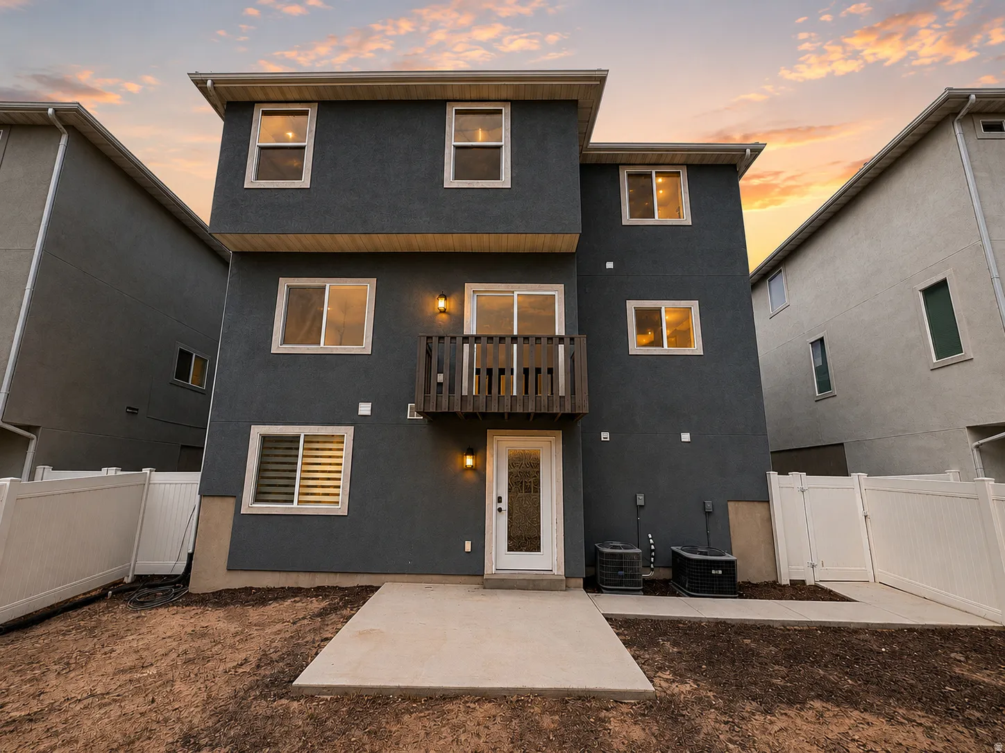 Multi-level exterior with dark gray stucco finish