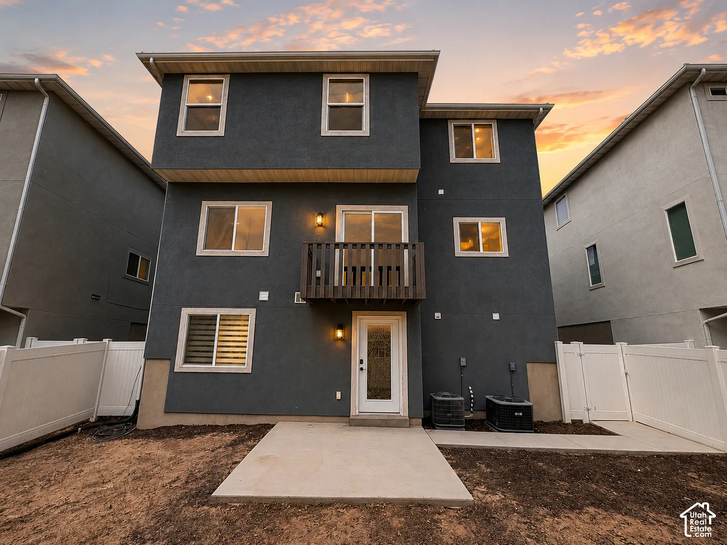 Multi-level exterior with dark gray stucco finish