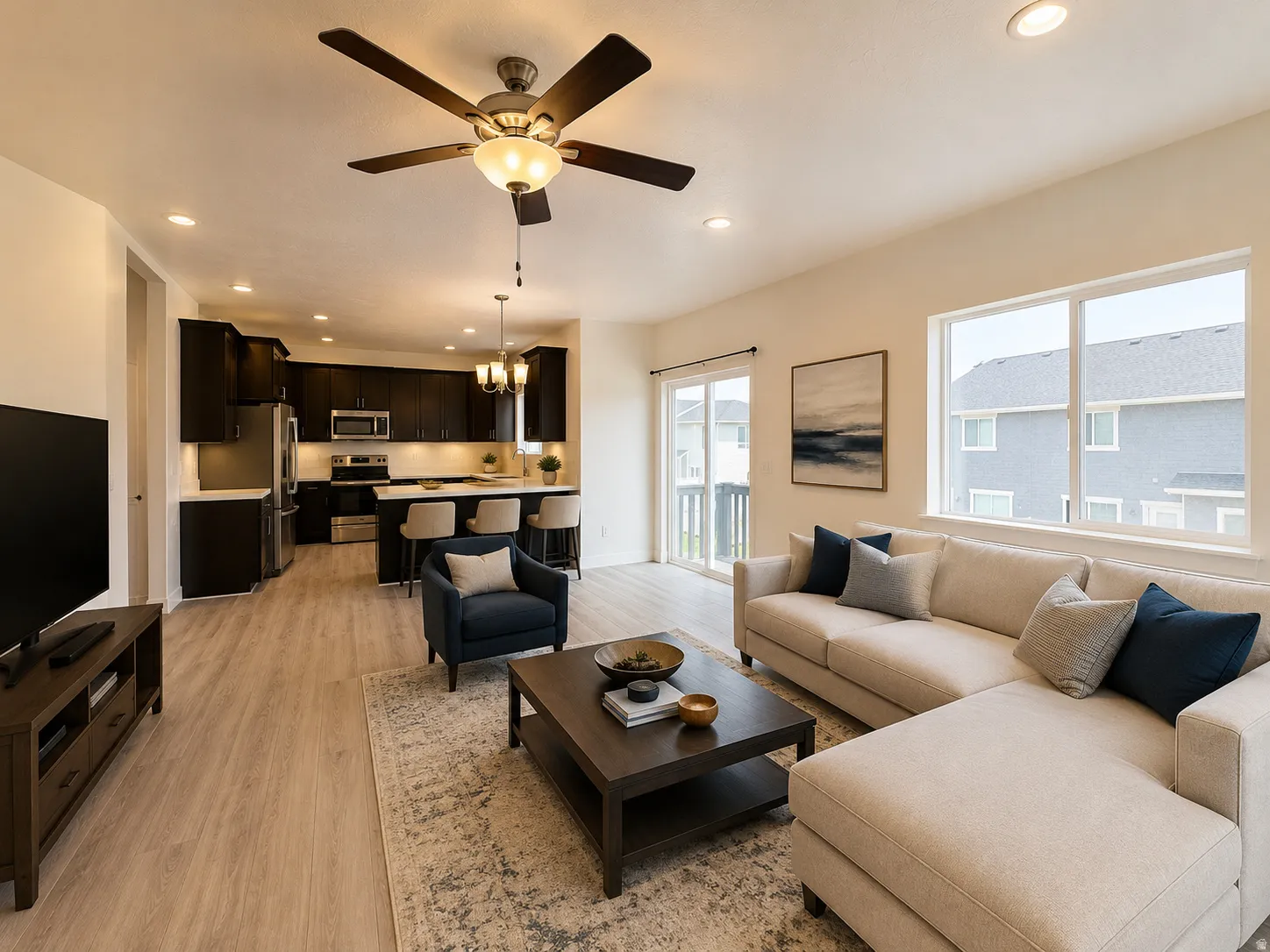 Open-concept living area featuring wood-finish flooring, recessed lighting, and a ceiling fan