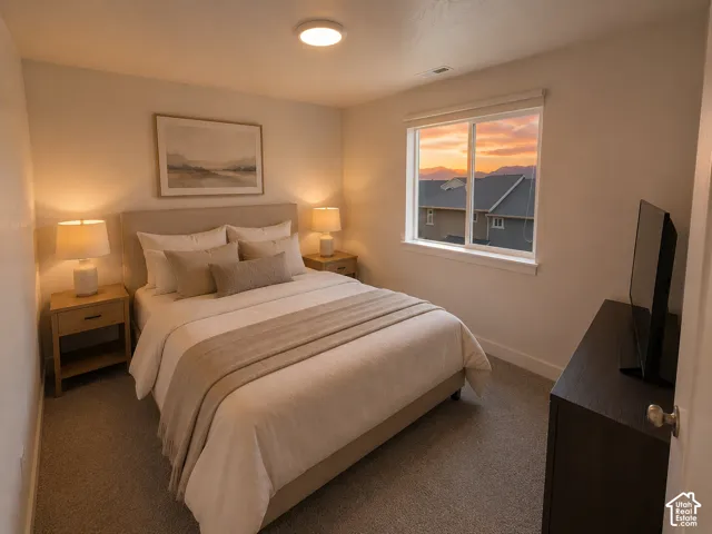 Carpeted bedroom with a single window, a light-colored headboard, and two built-in ceiling lights