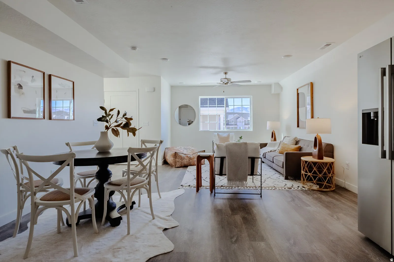 Open-concept living space featuring wood-finish flooring, recessed lighting, and a ceiling fan