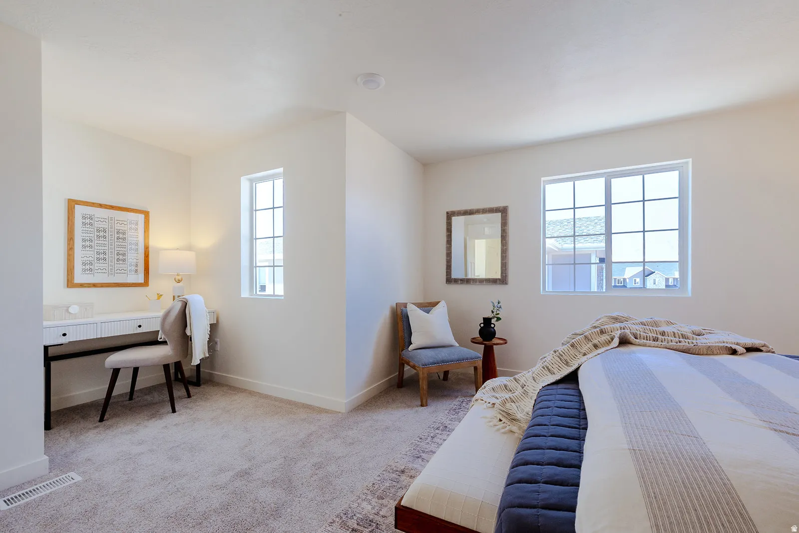 Carpeted interior with light-colored walls, featuring multiple windows, and a built-in recessed light fixture
