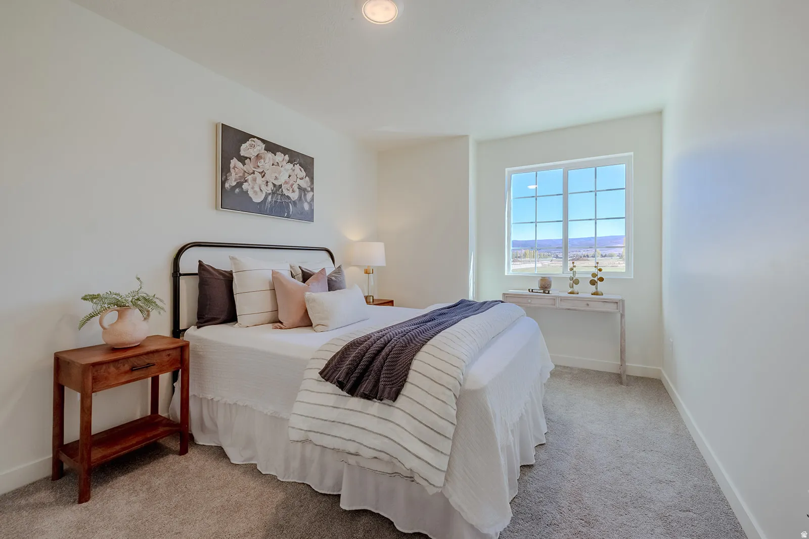Bright room featuring a large gridded window, recessed ceiling lighting, and soft gray carpeting