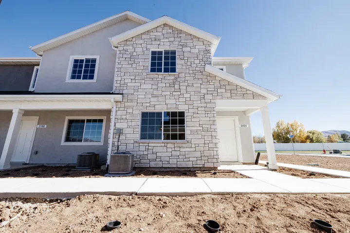 Multi-level facade featuring stone veneer and stucco finishes