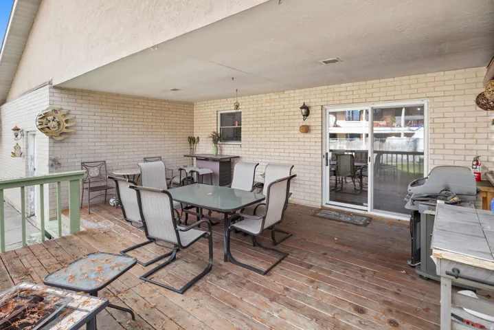 Wooden deck featuring outdoor dining area and area for grilling