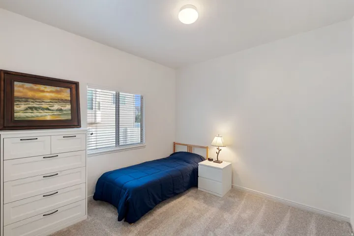 Neutral wall paint with textured carpet flooring