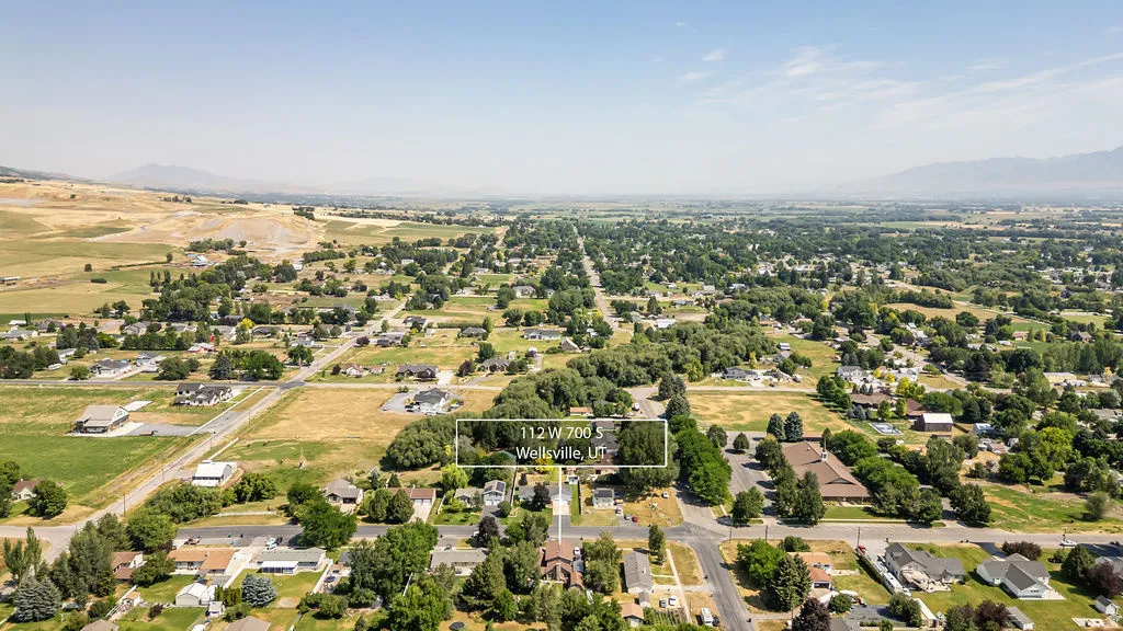 Aerial perspective showcasing the property within a structured residential area with mature tree cover