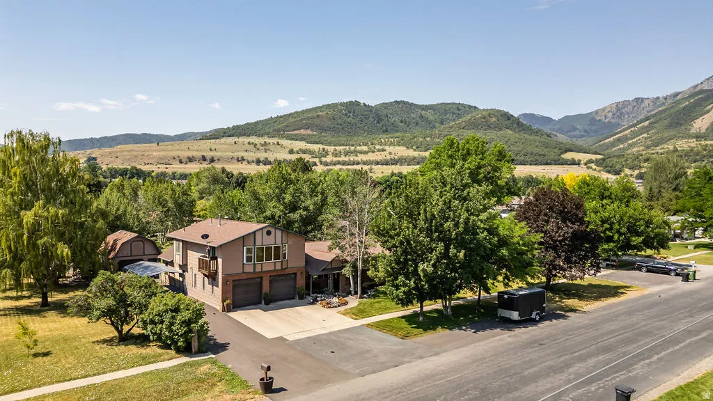 Two-story residence with a brown exterior and a multi-car garage