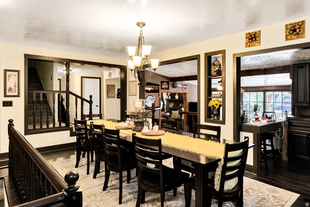 Formal dining space featuring dark wood-finish flooring and a light-toned area rug