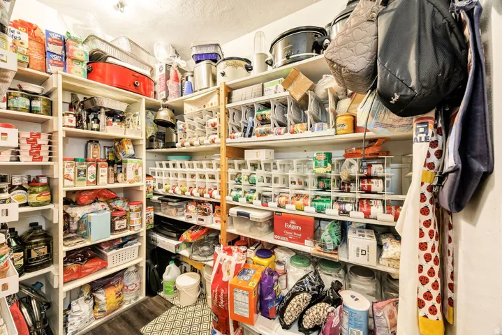 Expansive storage pantry featuring multiple built-in shelving units for organized storage