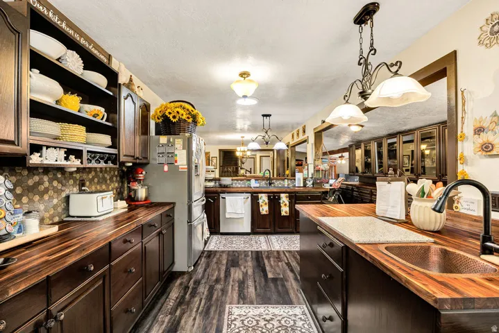 Kitchen featuring dark wood-finish cabinetry and butcher block countertops