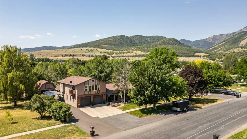 Two-story residence with a brown exterior and a multi-car garage