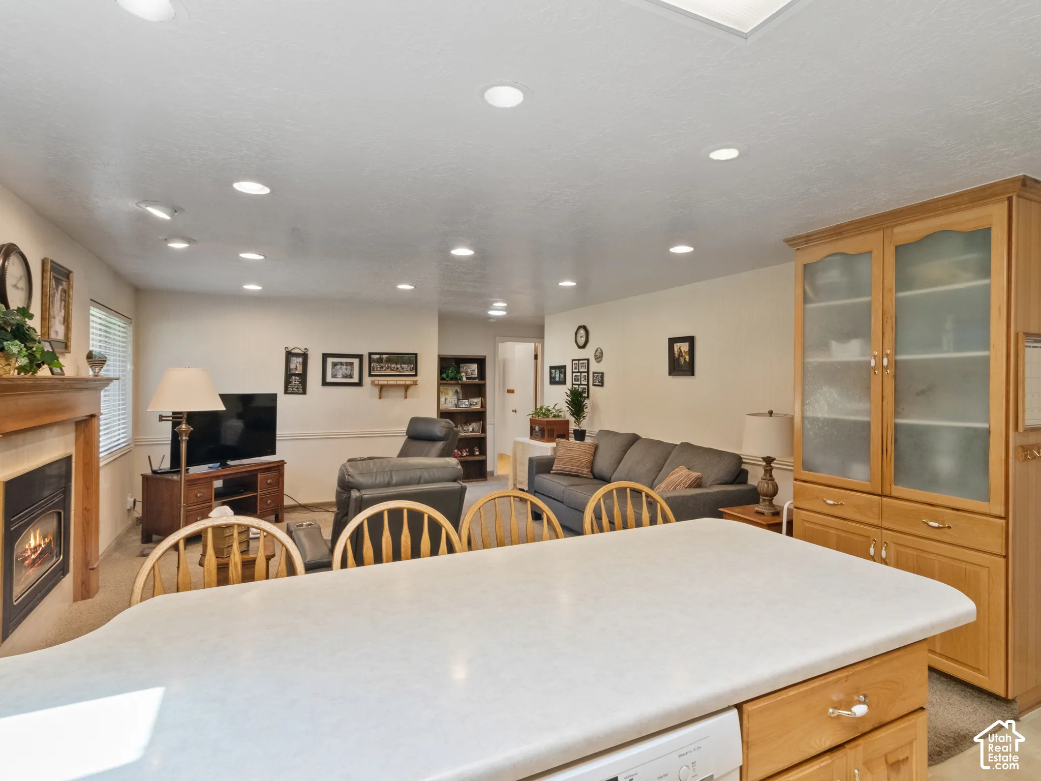 Kitchen island with a light-toned countertop and integrated dishwasher