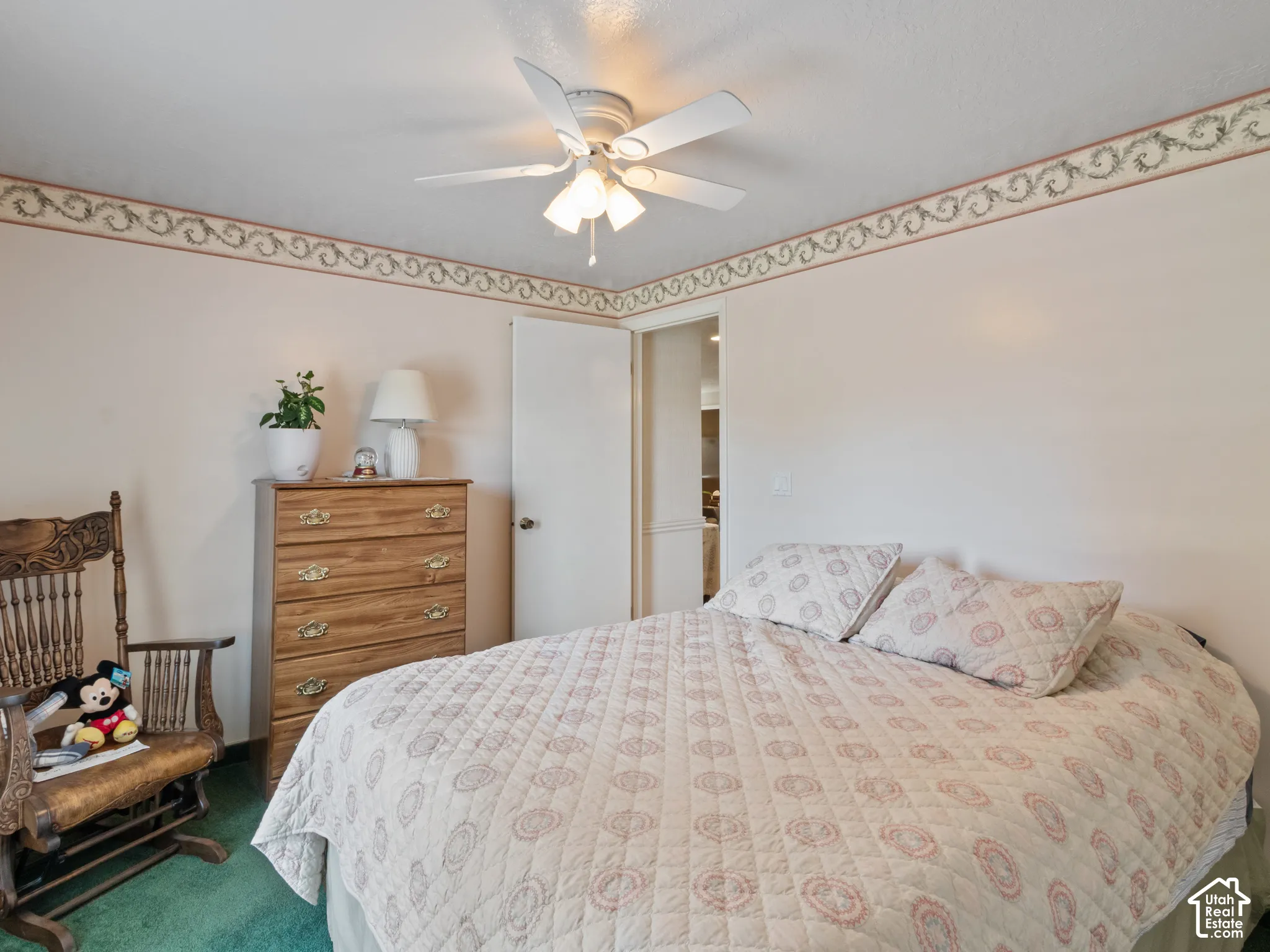 Interior room featuring wall-to-wall carpeting and a ceiling fan