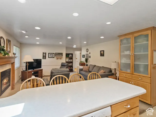 Kitchen island with a light-toned countertop and integrated dishwasher