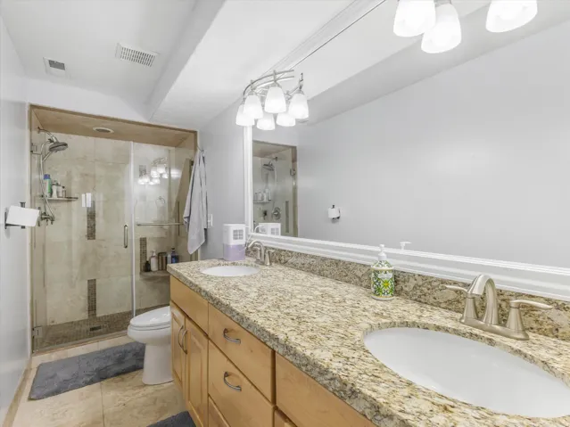 Double vanity featuring granite countertops and undermount sinks