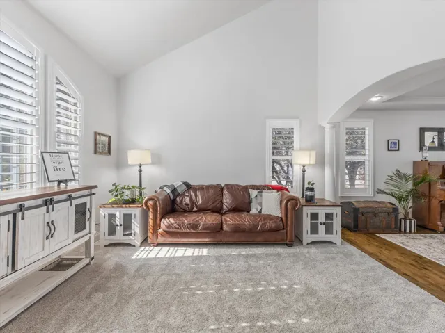 Living space featuring vaulted ceilings and abundant natural light from multiple windows