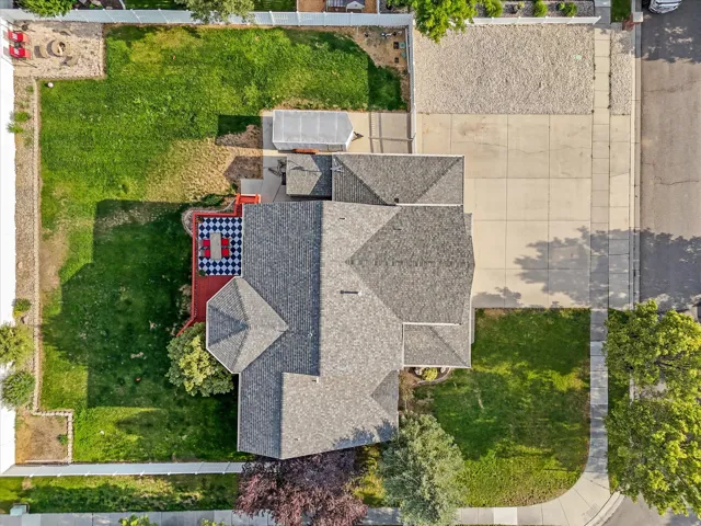 Expansive property featuring a multi-gabled roofline, a patterned patio area, and a substantial concrete driveway