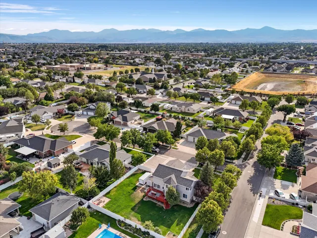 Aerial perspective showcasing a residential neighborhood with distant mountains