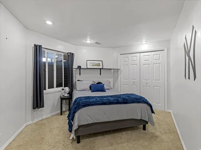 Bedroom featuring neutral-toned carpeting and white walls