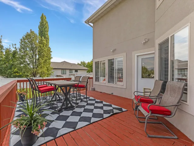 Spacious wood-finish deck with red railings