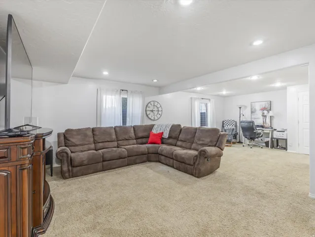 Carpeted recreation room with recessed lighting and neutral wall tones