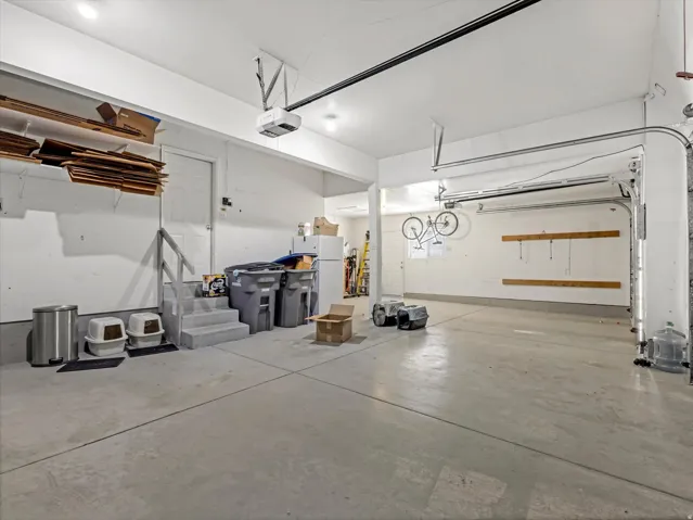 Spacious garage featuring concrete flooring and white painted walls