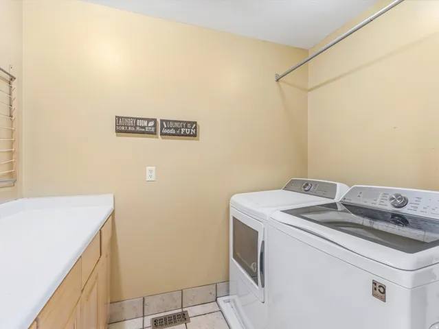 Dedicated laundry space featuring a side-by-side appliance setup