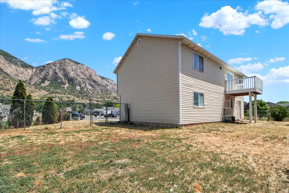 Two-story exterior with vinyl siding and a rear elevated deck