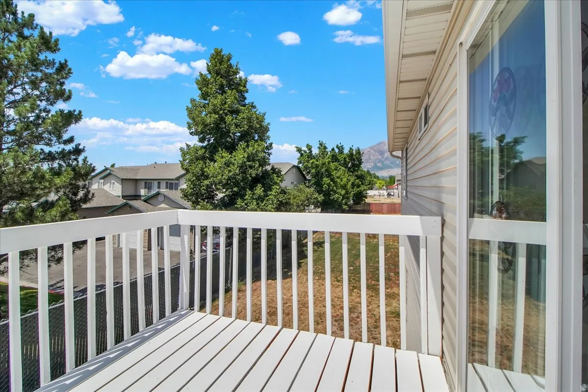 Exterior deck with white painted wood-plank flooring and railing