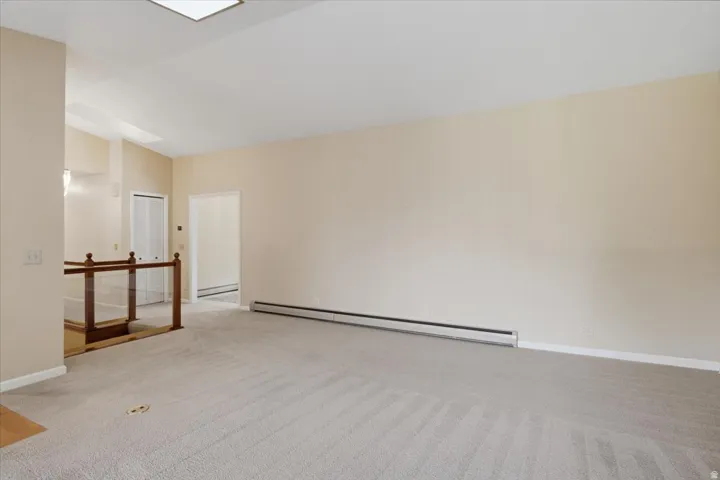 Spacious interior featuring neutral carpeting and light-toned walls