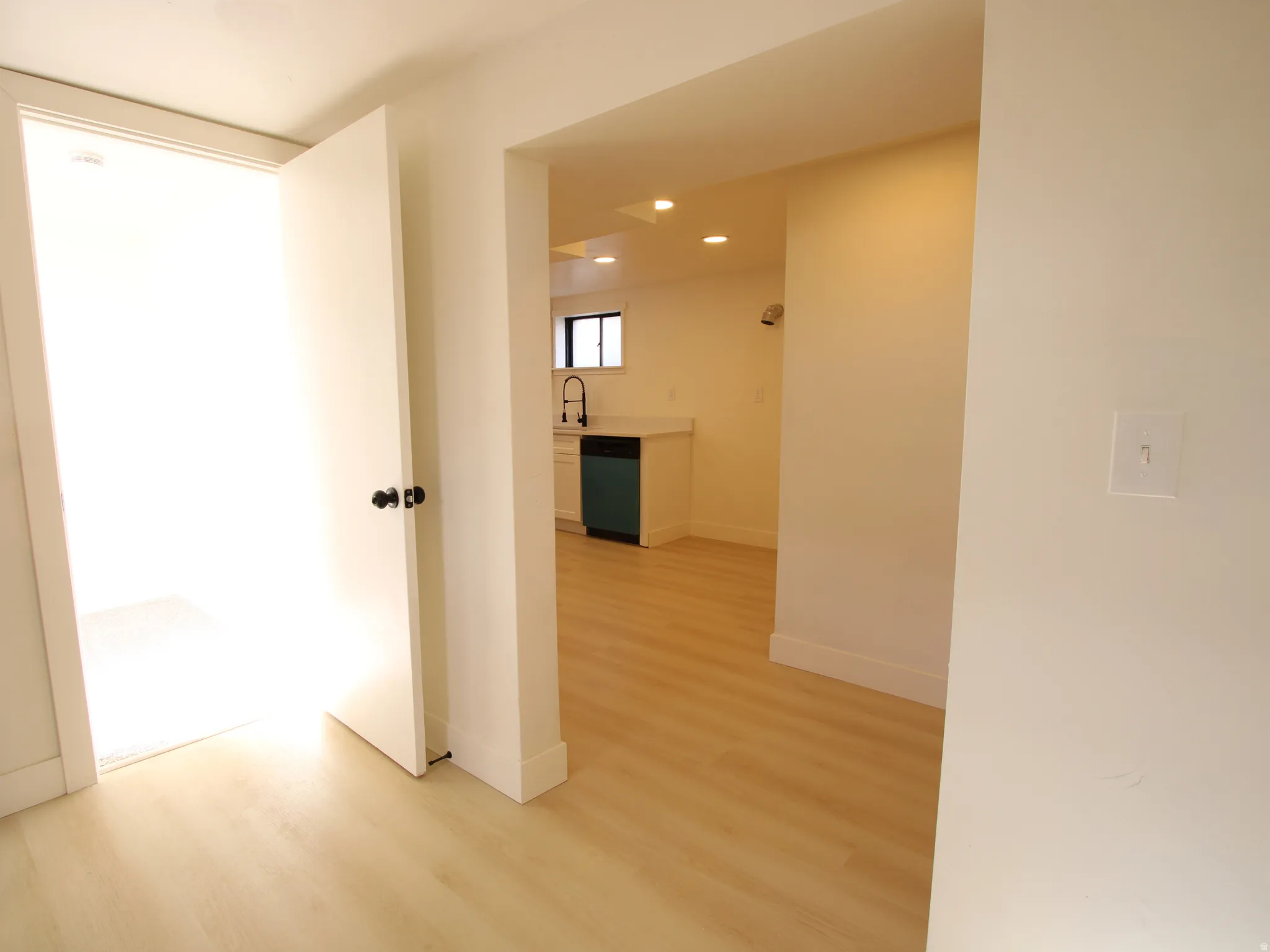 Light wood-finish flooring extends through multiple areas