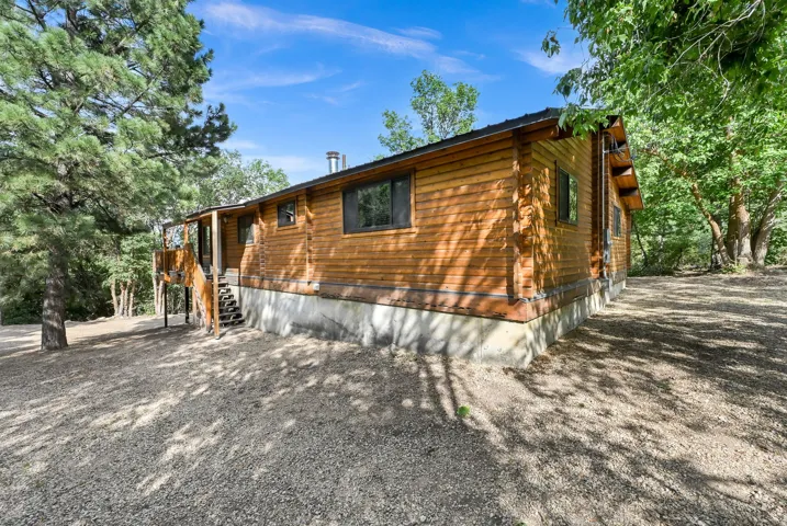 Wood-sided exterior with a gravel perimeter and covered entry