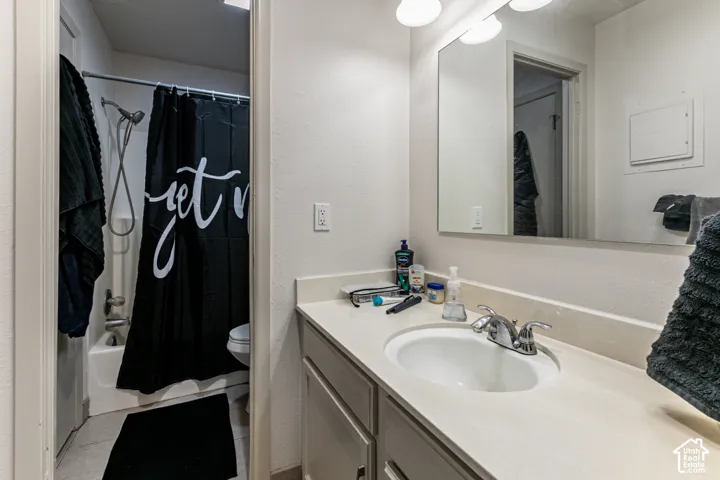 Bathroom vanity with an integrated sink, polished chrome faucet, and a large wall-mounted mirror