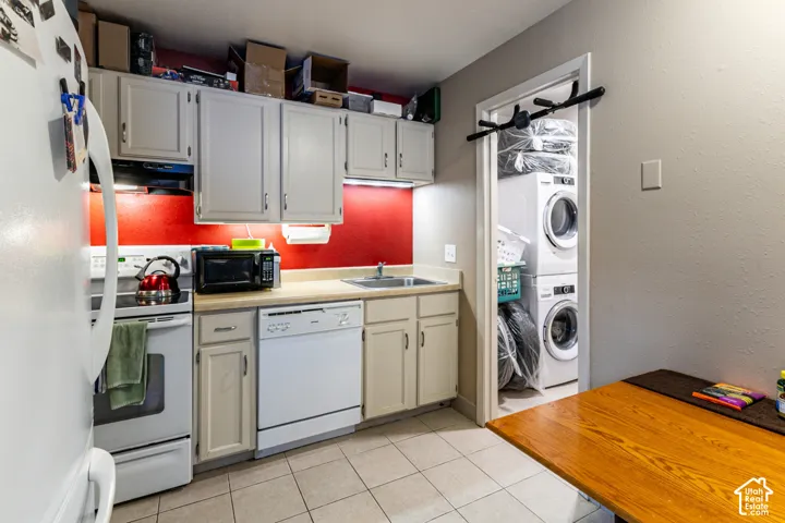 Kitchen featuring light cabinetry, a white electric range, and a dishwasher