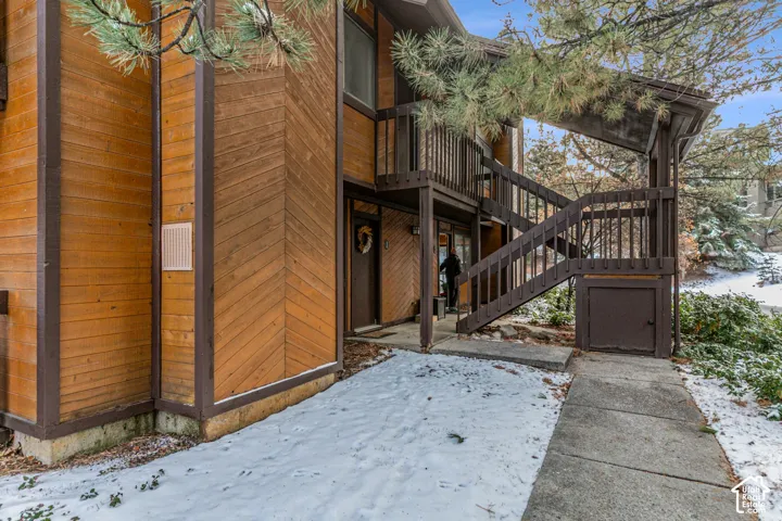 Wood-paneled exterior featuring a covered entryway