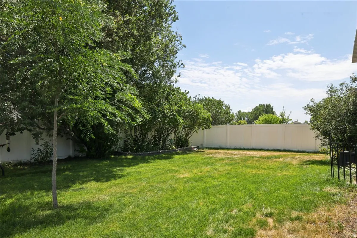 Spacious backyard featuring a lush lawn and perimeter landscaping