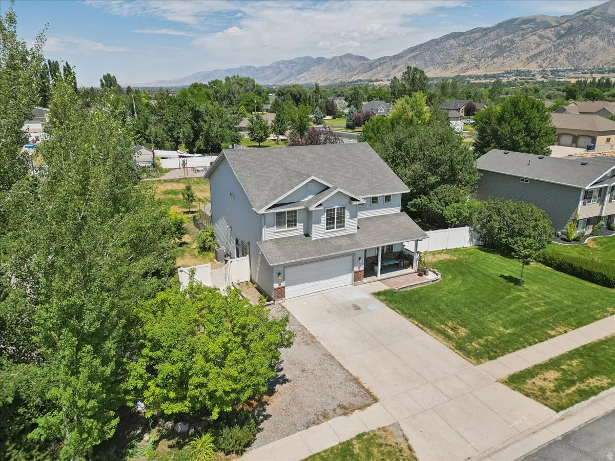 Two-story residence featuring a covered front porch, an attached two-car garage, and a concrete driveway