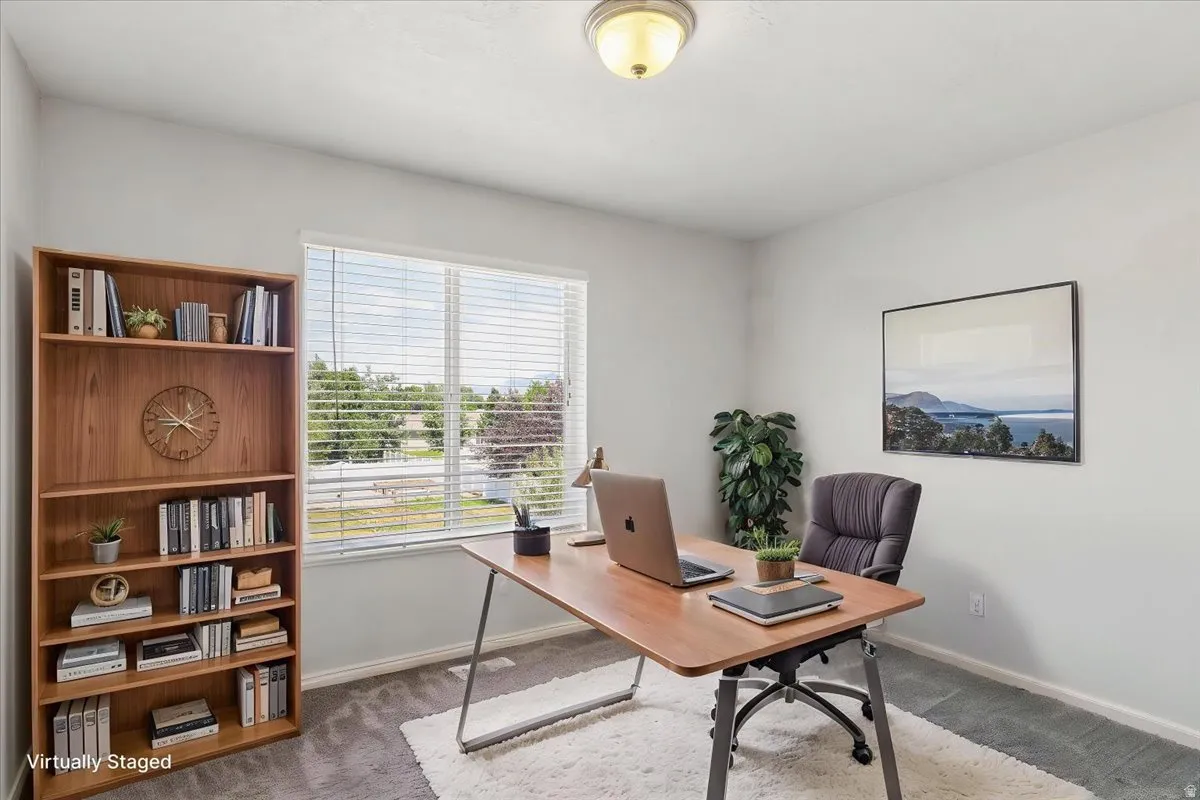 Bright room with a large window featuring horizontal blinds