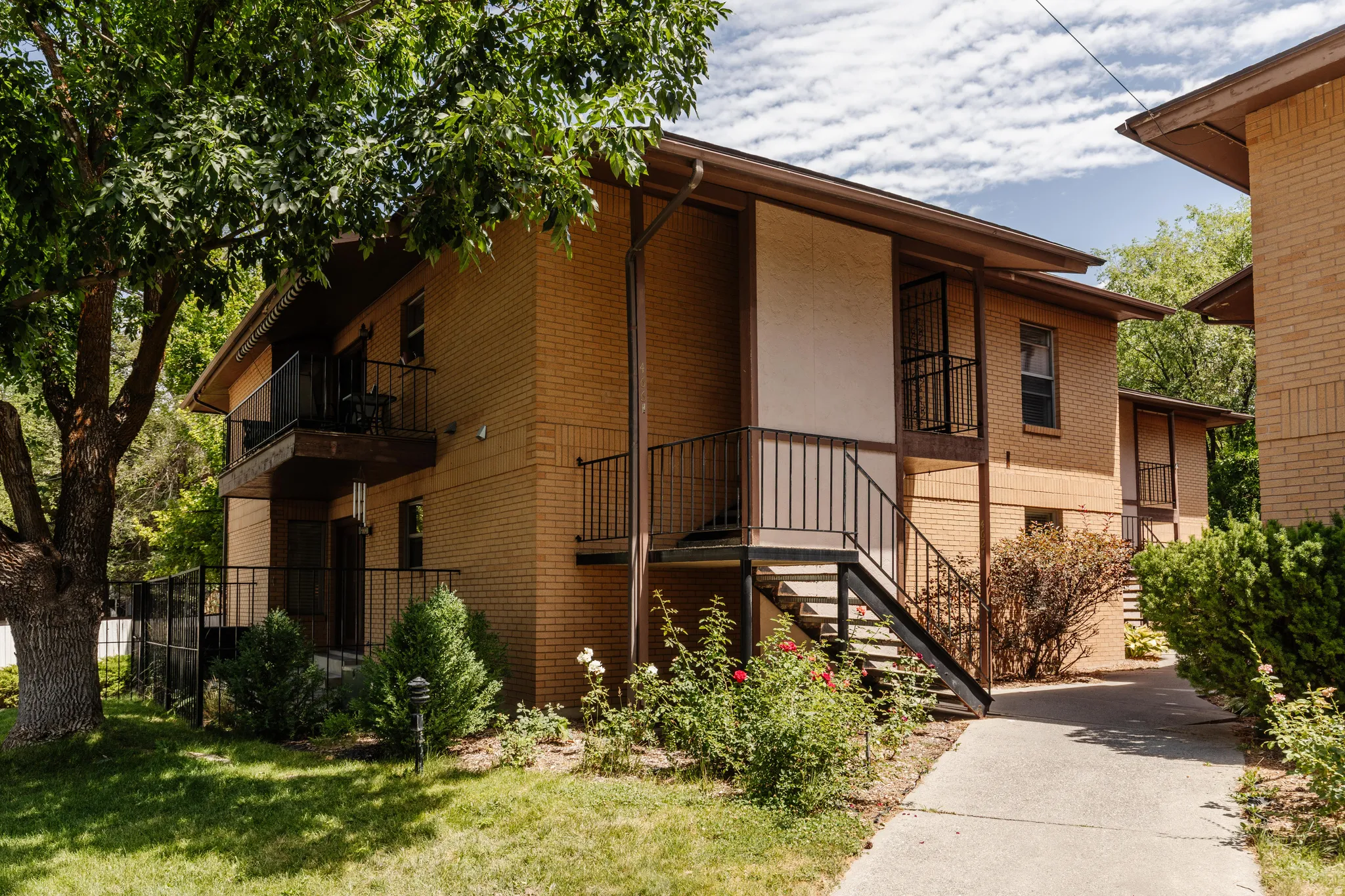 Brick exterior with multiple private balconies and black wrought iron railings