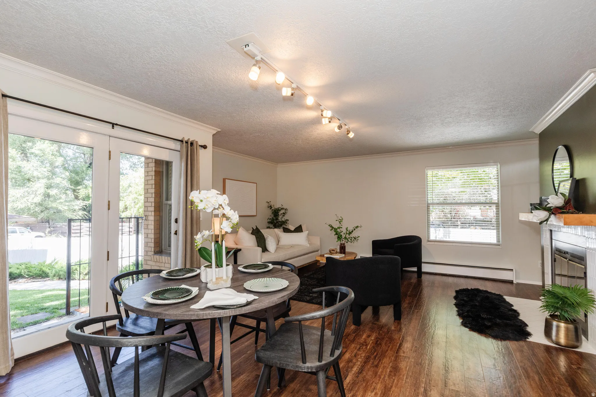 Hardwood-finish flooring extends through the open-concept living and dining areas